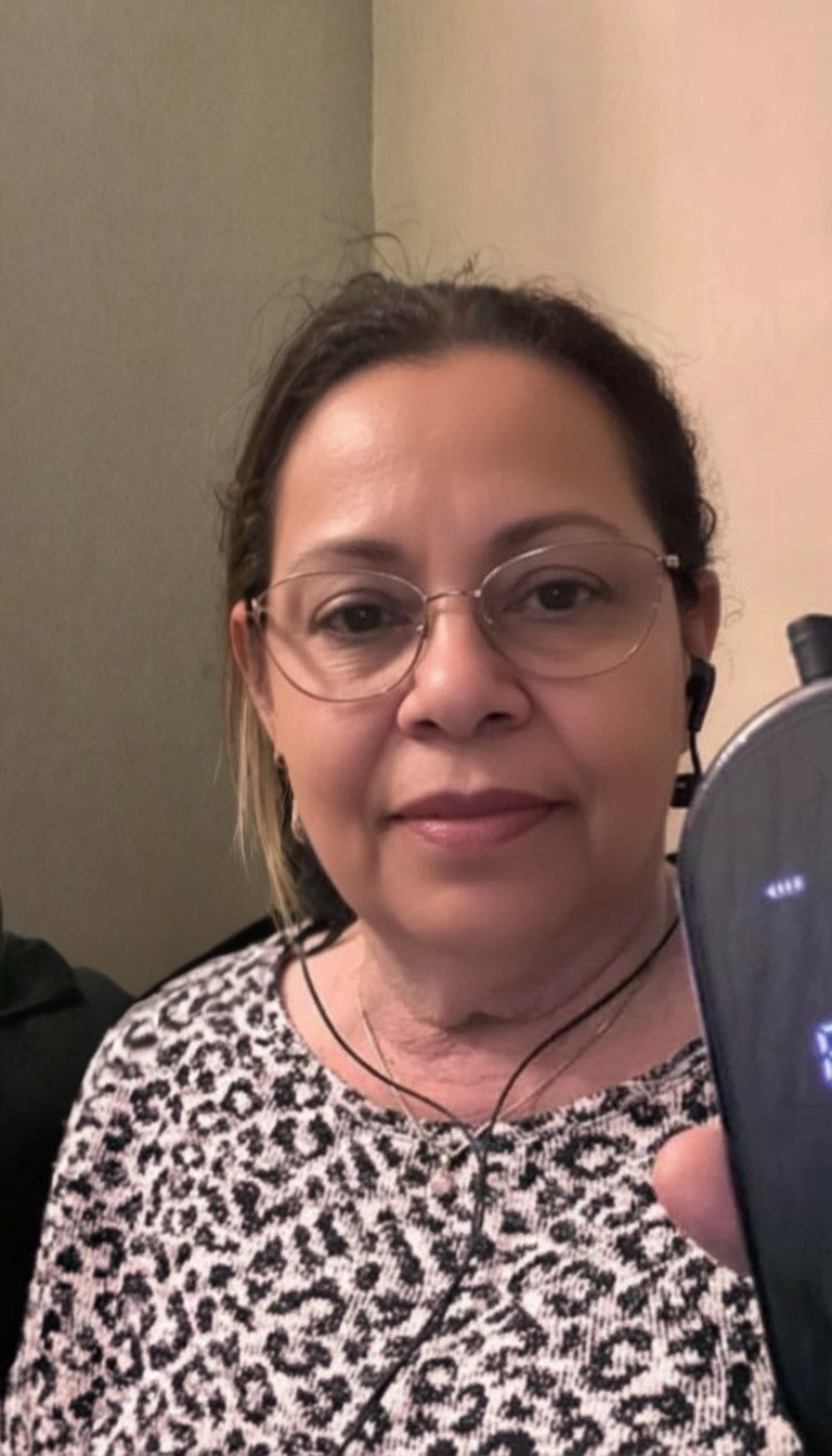 NeuroRest-Woman wearing glasses and a leopard print top in an indoor setting